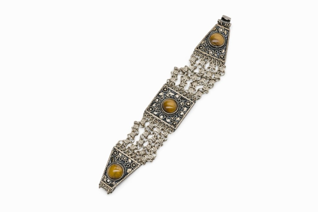 Sterling Silver Filigree Tigers Eye Bracelet: Vintage Judaica .925 sterling silver filigree tigers eye bracelet. Stamped 'Israel Sterling 925' on inside of middle decoration. Signs of wear and some tarnishing, otherwise in good condition. Weight