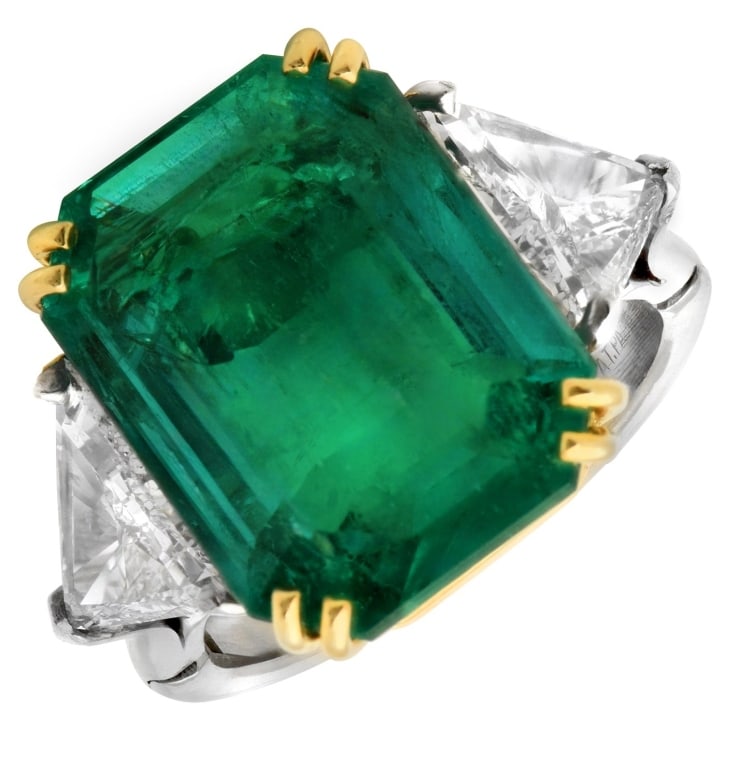 Emerald & 2Ct Trillion Diamond Ring: 10.14Ct Vivid Green Emerald & 2Ct Trillion Diamond Ring in Platinum & 18K Yellow Gold SKU: 49149 Discover the epitome of opulence with this stunning emerald diamond engagement ring, a true masterpiece