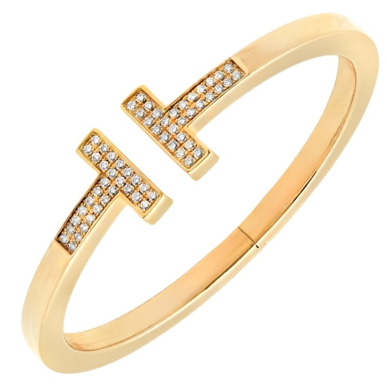 18k Tiffany & Co T Bracelet: 18k Tiffany & Co T Bracelet -V52007 A modern icon of sophistication, this Tiffany & Co. T bracelet embodies the clean lines and architectural elegance that define the celebrated T collection. Crafted