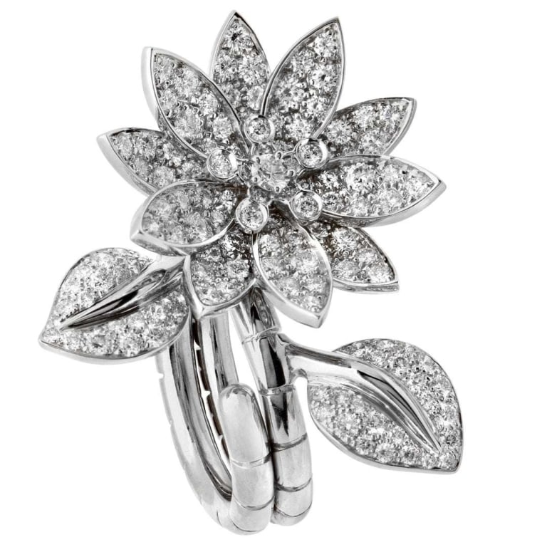 18k White Gold VCA Lotus Between the Finger ring: 18k White Gold VCA Lotus Between the Finger ring -V51399 An iconic expression of Van Cleef & Arpels’ poetic artistry, this Lotus Between the Finger ring captures the ethereal beauty of a blooming fl