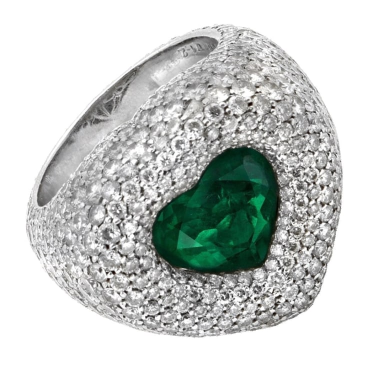 De Gisogono Emerald Ring: De Gisogono Emerald Ring - V50596 A dazzling fusion of bold design and exceptional rarity, this De Grisogono emerald and diamond ring showcases the Maison’s signature flair for dramatic luxury. At i