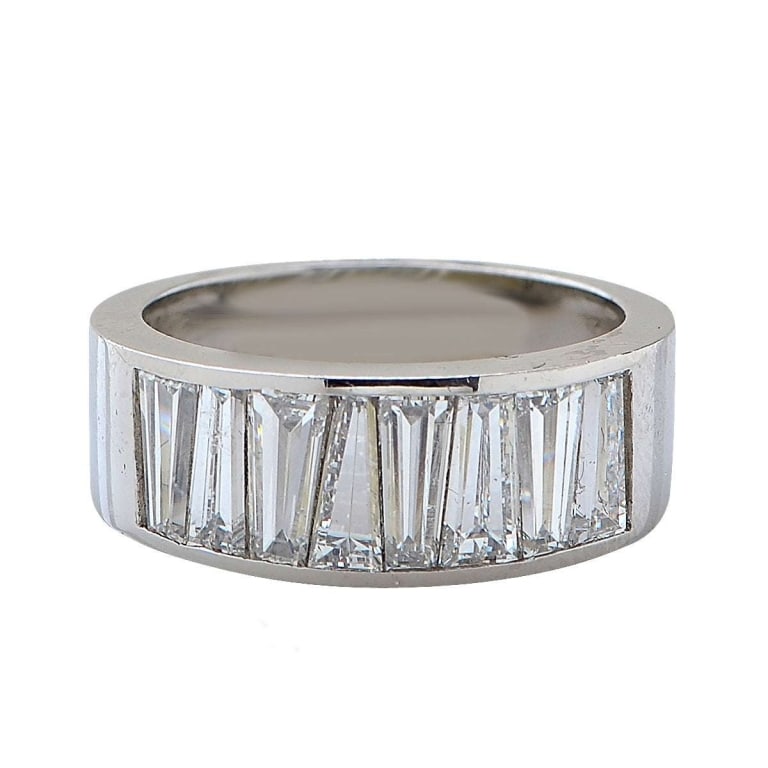 2.77 Carat Baguette Diamond Platinum Wedding Band: Platinum Wedding Band - V30564-1 A timeless expression of elegance and precision, this platinum diamond wedding band features a seamless array of tapered baguette-cut diamonds totaling 2.77 carats. Ea