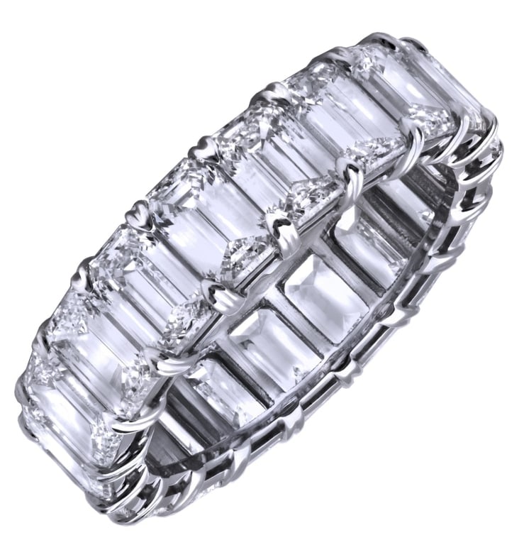 Platinum 6.03ct Emerald-Cut Diamond Wedding Band: Platinum 6.03ct Emerald-Cut Diamond Wedding Band – V37022-1 SKU: 37022-1 A masterpiece of elegance, this platinum wedding band features 19 emerald-cut diamonds totaling 6.03 carats. Their sleek geom