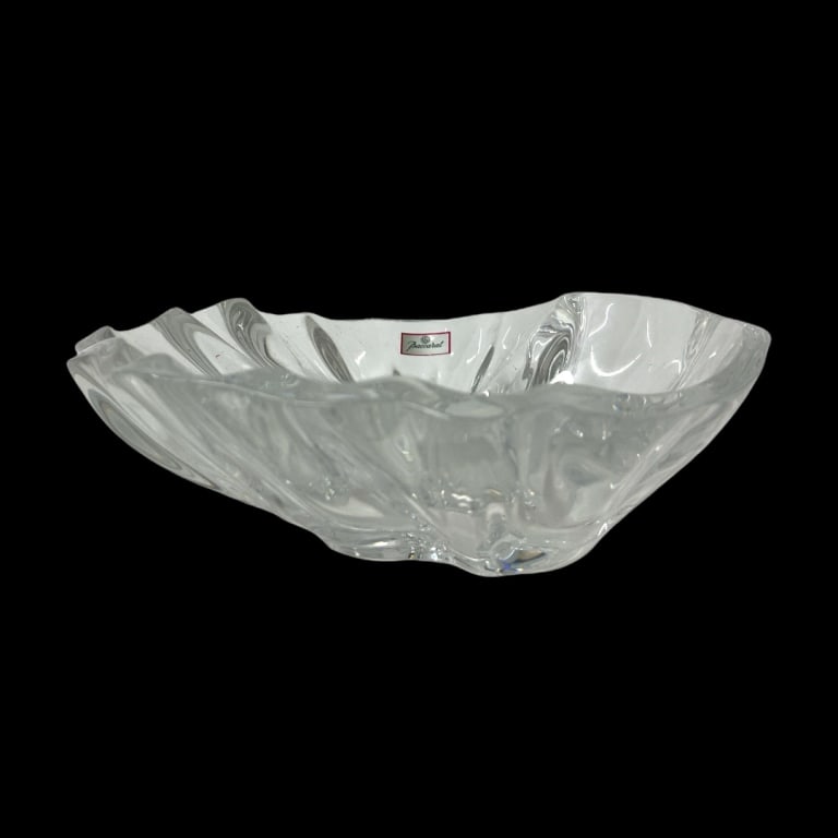 Baccarat France Oyster Shell Form Crystal Bowl: A Baccarat French clear crystal oyster shell form bowl. Has round acid mark to bottom and retains factory label. Measures approx. 10" width x 9 1/4" depth x 3" height. Has shelf scratching to bottom.