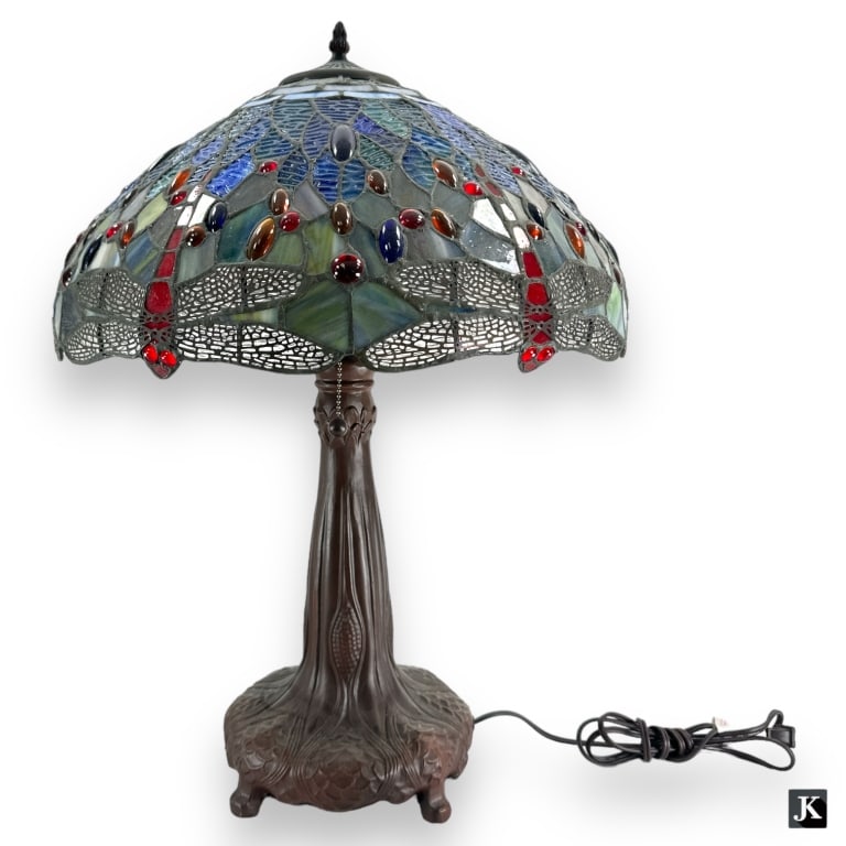 Tiffany Studios Bronze Dragonfly Glass Shade Lamp: A Tiffany Studios style bronze base table lamp with green dragonfly motif slag glass shade. Some signs of wear and age, otherwise in good condition. Measures approx. 24" height x 19" diameter. 105976