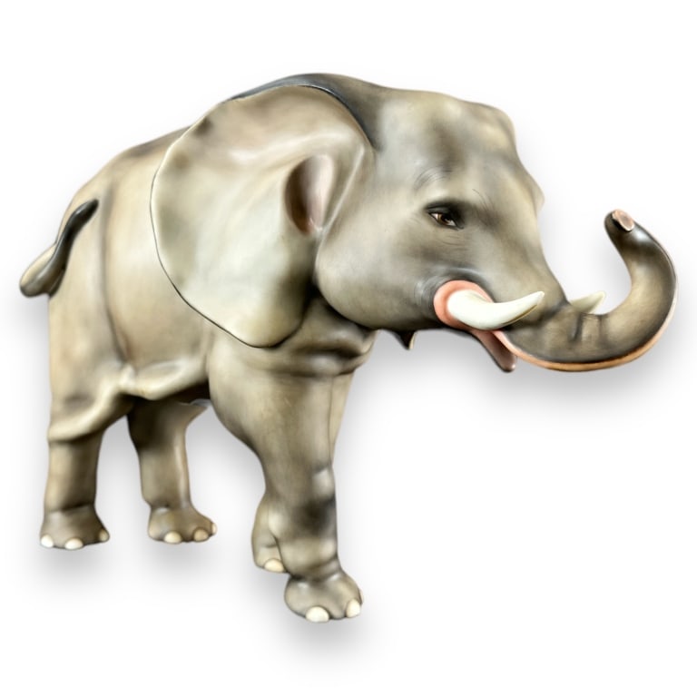 Large Herend Hungary Standing Elephant Sculpture: Large Herend Hungarian hand painted sculpture depicting a standing elephant. Blue marks to underside of foot. In overall good condition. Measures approx, 10" height x 14" length x 6" depth. 103980 2A