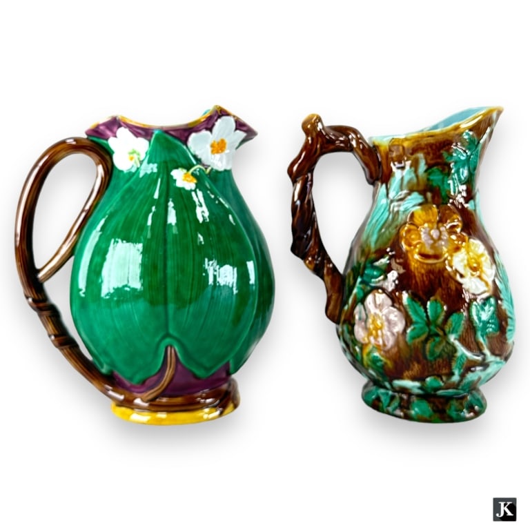 Lot 2 Italian Majolica Porcelain Handled Pitchers: A lot of 2 Italian Majolica porcelain handled pitchers to include Mottahedeh leaves and flowers pitcher and an unmarked birds floral pitcher. Birds pitcher shows crazing throughout interior, both show