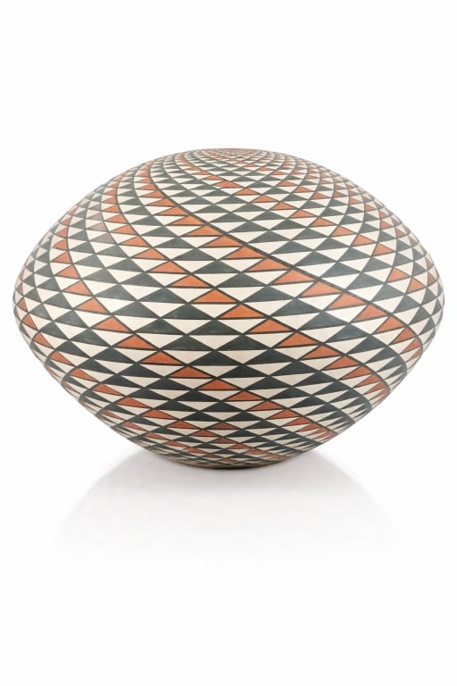 Robert Kasero Sr. Laguna New Mexico Pottery Vase: An artisan signed Robert Kasero Senior hand painted thin pottery vase having a precise geometric design. Signed to bottom. In overall good condition. Measures approx. 6 1/8" height x 9" diameter. 1061