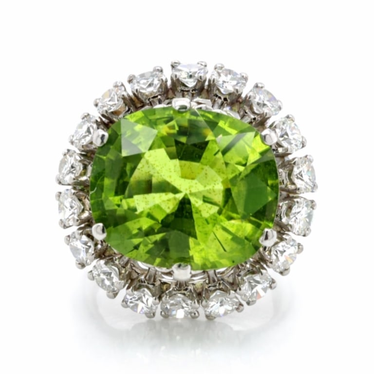 1960’s Platinum Peridot & Diamond Ring: Item # 13761Category Rings1960’s Platinum Peridot & Diamond RingWeighing 13.4 gramsSet with an app. 8.00 Ct. PeridotAlong with 18 Diamonds weighing app. 1.25 Ct.F-G Color, VVS-VS ClarityRing Size 6.