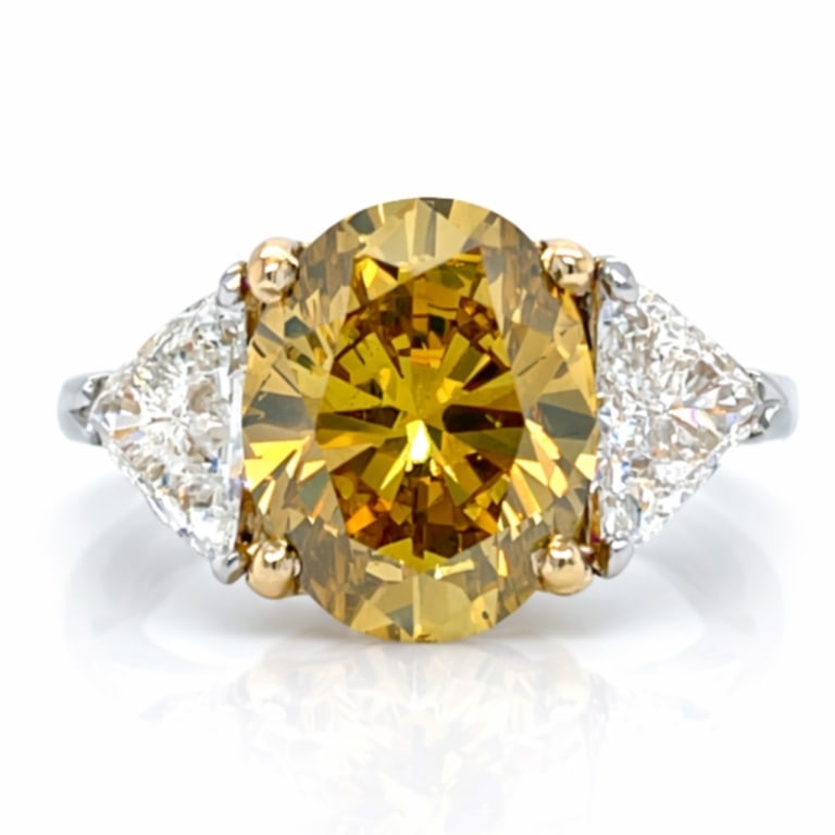 Platinum & 18K GIA Certified 3.69 Ct. Fancy Diamon: Item # 13744Category RingsPlatinum & 18K GIA Certified 3.69 Ct. Fancy Diamond RingWeighing 6.9 gramsSet with a GIA Certified 3.69 Ct. Oval DiamondFancy Deep Brownish Yellow ColorSI1 Clarity11.48 x 9.1