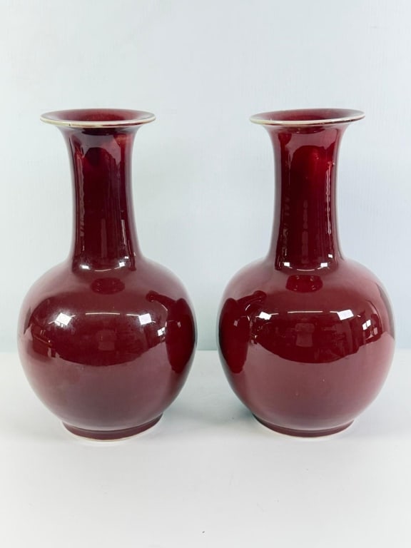 A pair of Chinese porcelain antique ox blood vases: A pair of Chinese porcelain antique ox blood vases. antique Measures: approximately 16 1/2 inches high by 9 inches diameter. JZ11B