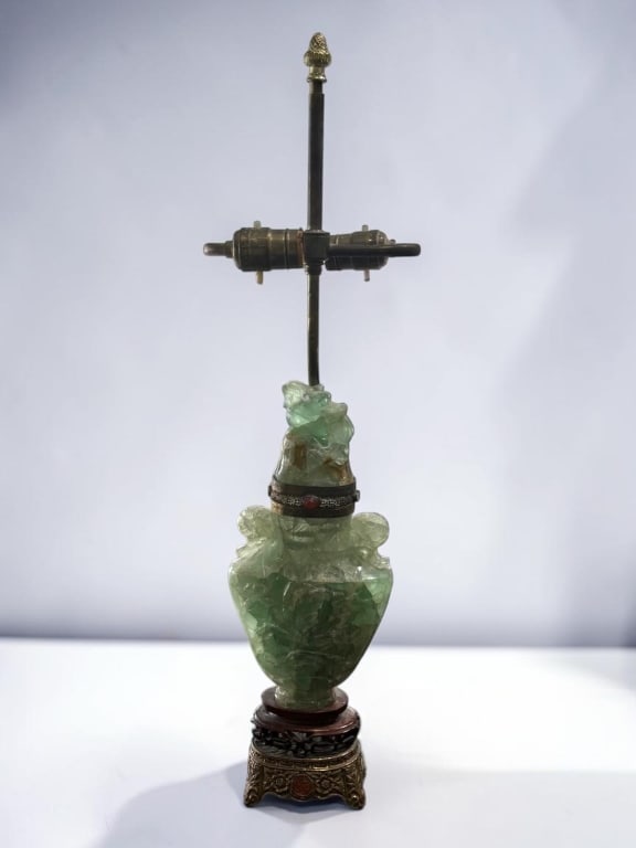 Chinese Carved Green Hardstone Urn Lamp Base: Chinese Carved Green Hardstone Urn Lamp Base Chinese carved green hardstone urn-form lamp base with relief-carved decoration, animal-form handles, and a carved mythical beast finial. Mounted on a carv