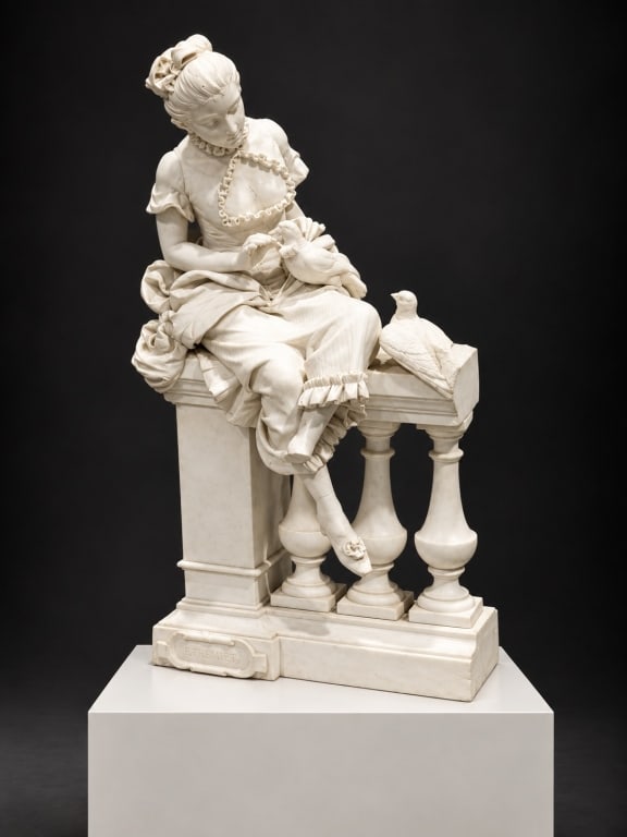 Signed Figural Sculpture of a Lady with Birds: Signed Figural Sculpture of a Lady with Birds A large white composition figural sculpture depicting an elegantly dressed seated young woman interacting with birds, modeled with elaborate drapery and