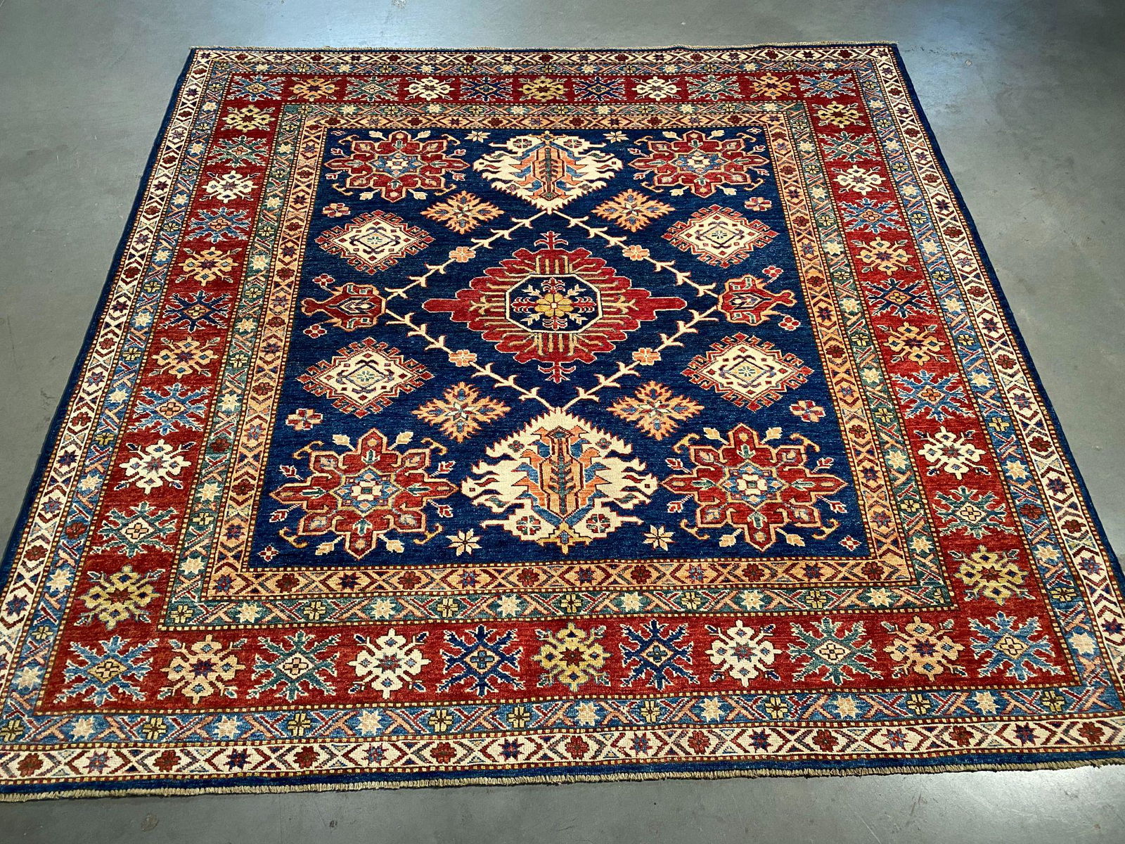 FINE SQUARE SUPER KAZAK RUG 6.7: 6'.7"X6'.5" Super quality Kazak square rug, hand spun and hand knotted rug in Pakistan 100% natural wool with beautiful sheen pile, in vivid Navy Blue , Red , Ivory and multi accent colors