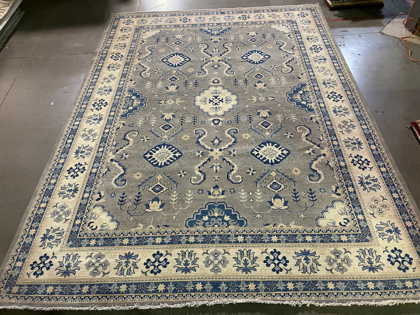 FINE SUPER KAZAK RUG 9'x12': 9'x12' Super quality Antique design Kazak Rug, hand spun and hand knotted rug in Pakistan 100% Vegge Dye natural wool Pile in Antique finish , Muted Grey , blue and Ivory colors.