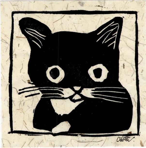 Oddscrew: The Cat Woodblock: Woodblock Print, 2026s SIZE IN INCHES: 4 x 4 inches COMMENTS: This is a black-and-white block print of a wide-eyed black cat with white whiskers, a white patch on its chest, and a white paw, framed wi