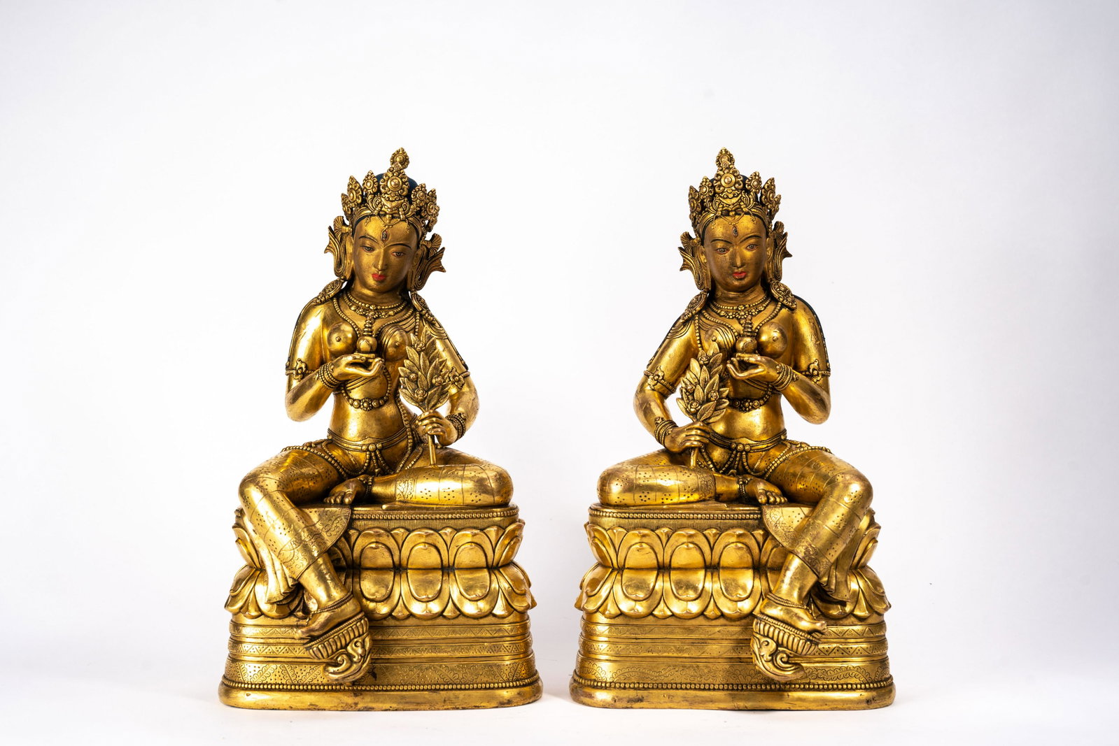 Pair of Rare Mongolian Gilt Copper Figures of Tara: Pair of Rare Mongolian Gilt Copper Figures of Tara Pair of Rare Mongolian Gilt Copper Figures of Tara, 18/19th C. Each seated on double lotus stand, one hand holding a stupa and the other holding leaf