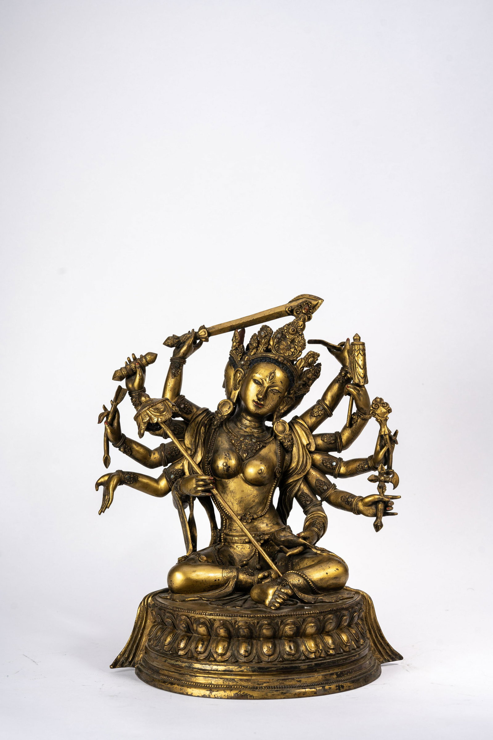 Mongolian Gilt Copper Figure of Ushnishavijaya: Mongolian Gilt Copper Figure of Ushnishavijaya Mongolian Gilt Copper Figure of Ushnishavijaya, Qing period. Double lotus stand, with eight radiating arms holding various attributes, three faces wearin