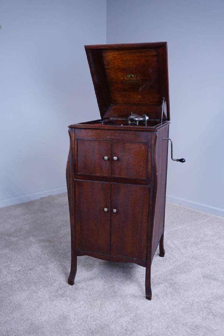 ANTIQUE MAHOGANY VICTROLA: ANTIQUE MAHOGANY VICTROLA - antique mahogany victrola by Victor Talking Machine Company; floor model with record storage inside; crank and needle included; working condition; model numbers VV90 67051