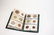 51 ASSORTED FOREIGN COINS IN COIN STOCK BOOK