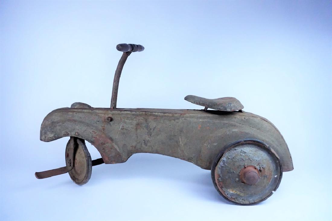 VINTAGE FRICTION POWERED PEDAL CAR: VINTAGE FRICTION POWERED PEDAL CAR - Does not move through use; rubber on wheels cracked/split, rust & paint loss; good condition for restoration ; Measures: 16.5"H x 31"L x 14"W ; Estimate: $200-$300