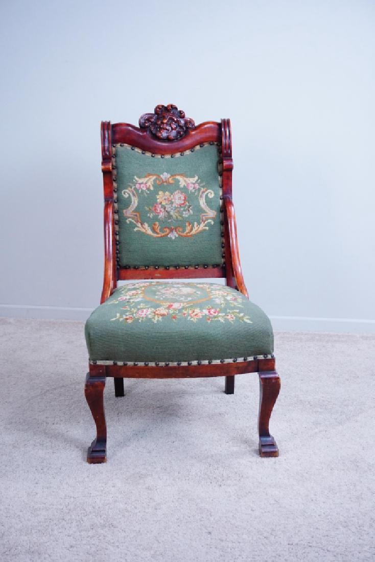 ANTIQUE NEEDLE POINT PARLOR CHAIR: ANTIQUE NEEDLE POINT PARLOR CHAIR - Needle point seat and back; carved north wind crest rail, hip sides and brass hobnail trim ; Condition - Repair in needle point seat ; Measures: 42"H x 22"W x 26"D 