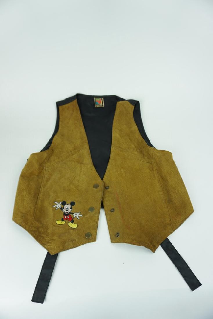 MICKEY UNLIMITED LEATHER CHILD’S SUIT VEST: MICKEY UNLIMITED LEATHER CHILD’S SUIT VEST – Mickey Unlimited Child’s suit vest; front of vest is leather with stitched Mickey Mouse on bottom right; ties in the back for sizing ; Condition - In
