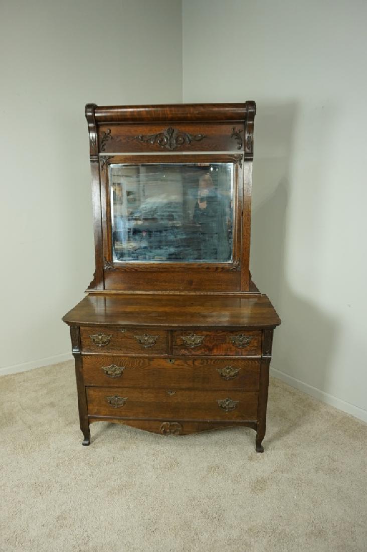ANTIQUE OAK DRESSER WITH MIRROR: ANTIQUE OAK DRESSER WITH MIRROR - Mirror is beveled and swivels; mirror is mercury and losing spots of the applied surface; dresser has 4 drawers using nails to construct; all hardware is brass ; Cond