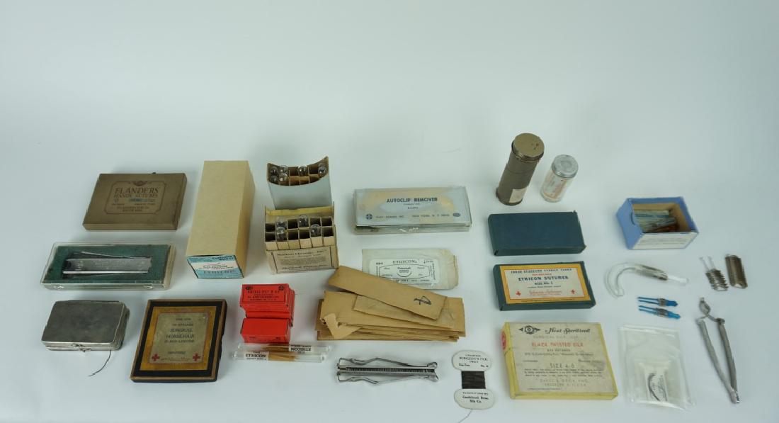 ASSORTED VINTAGE SUTURING ITEMS: ASSORTED VINTAGE SUTURING ITEMS - Includes: (5) Boxes of catgut sutures, Boxes of autoclips & autoclip appliers and (2) needle cases ; Condition - Cases are tarnished, boxes may be missing some conten