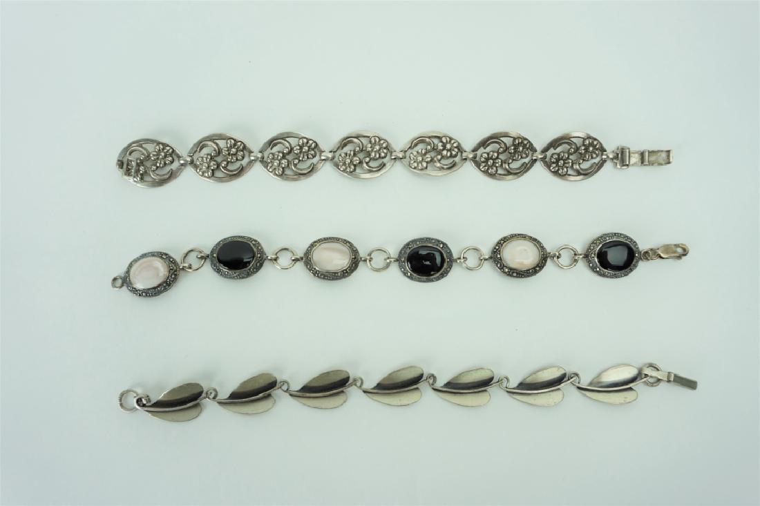 (3) STERLING SILVER LINK BRACELETS: (3) STERLING SILVER LINK BRACELETS – Includes (1) 6.5” white opalescent and onyx stones; (1) leaf shaped links; (1) floral pattern ; Measures: Total weight 44.1g