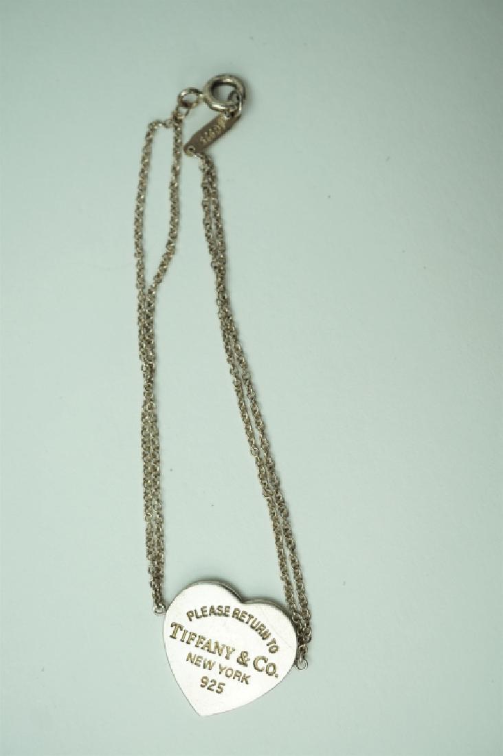 STERLING SILVER TIFFANY BRACELET: STERLING SILVER TIFFANY BRACELET – Heart shaped Tiffany charm in center of bracelet with double link chain bracelets on either side of the heart with springring clasp ; Measures: Total weight: 3.0g,