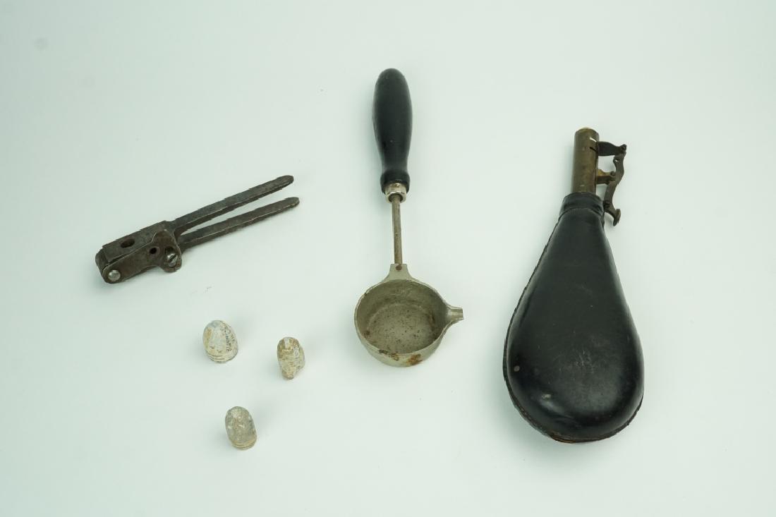 ASSORTED ANTIQUE RELOADING TOOLS: ASSORTED ANTIQUE RELOADING TOOLS Includes leather and brass powder flask, WWS marked wood handle pouring ladle, 32 caliber pistol bullet mold and 3 mini balls with locations they were found written on