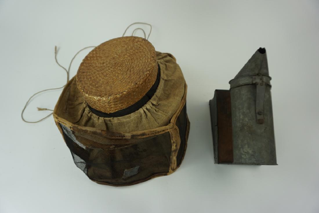 (2) ANTIQUE BEEKEEPERS HAT & SMOKER: (2) ANTIQUE BEEKEEPERS HAT & SMOKER Smoker: A-1 Root Company Ohio, made from leather, metal & wood; Hat: Harvard Straw hat with metal and linen veil, tag inside ; Condition - Hat is in poor condition 
