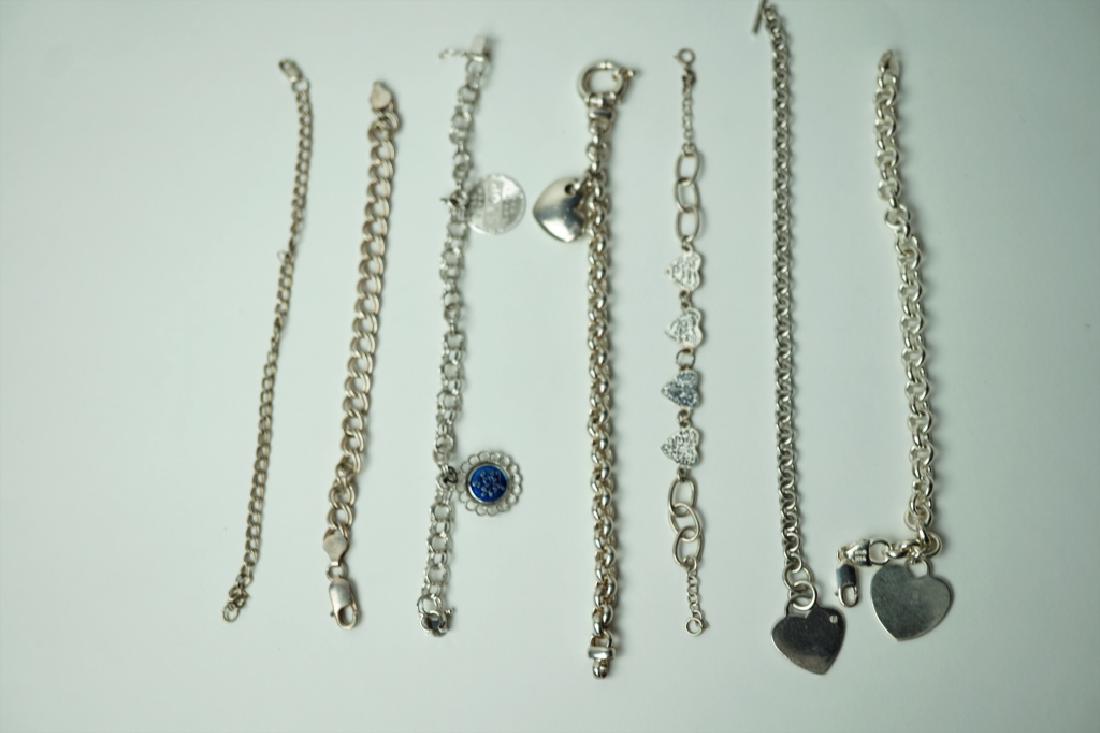 (7) STERLING SILVER CHARM BRACELETS: (7) STERLING SILVER CHARM BRACELETS – (2) have no charms, (4) have heart charms and (1) has round charms ; Measures: Total weight: 89.8g; 6" g
