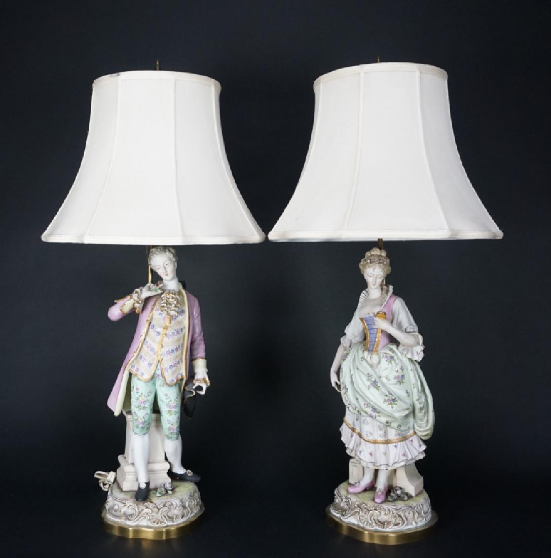 PAIR OF FRENCH FIGURAL PORCELAIN LAMPS: PAIR OF FRENCH FIGURAL PORCELAIN LAMPS - Man and a woman both sitting on pedestals; woman is looking into a mirror ; Condition - Man has flower and pinky finger missing from hand; woman is missing ind