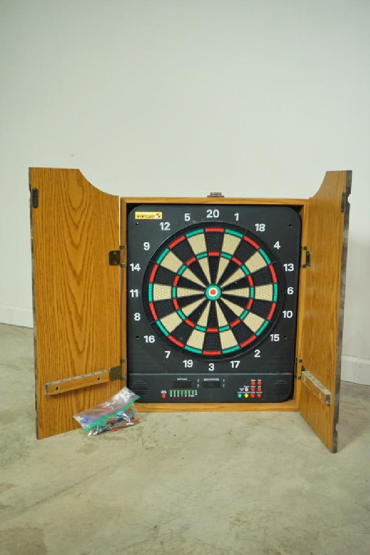ELECTRIC DART BOARD IN FITTED WALL CABINET: ELECTRIC DART BOARD IN FITTED WALL CABINET Sport craft dart board with sound and digital score keeping up to four players. Comes with assorted darts and pieces. ; Condition - No power cord. ; Measures