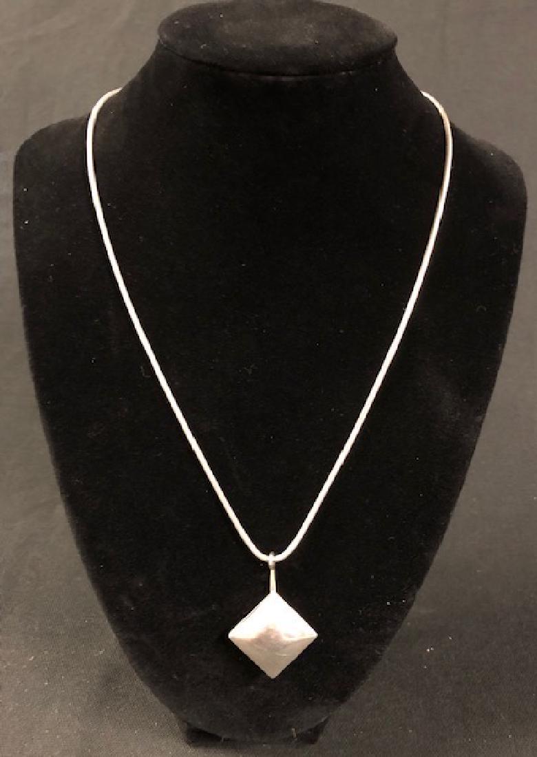 Vintage Ladies Sterling Silver Pendent and Snake Chain: Description: Nice, vintage sterling silver polygon shaped pendent, suspended on a sterling snake chain. Simple, yet not stark and a little different to avoid blending in with the crowd. Material: ster
