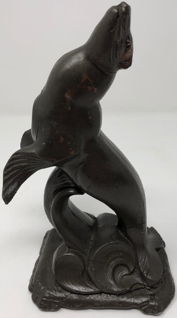 Le Verrier-Style Art Deco Seal: Description: Art deco Max Le Verrier-style joyful heavy metal/spelter cast sculpture of a seal breaking the water. Slight crack at tail. Measurement: approximate 9"h x 4"w (INCHES). Shipping cost: $17