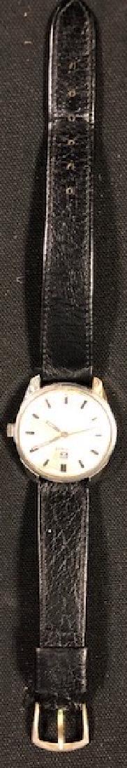 Vintage men's Tissot watch: Description: Vintage men's Tissot watch with black leather band. Slight crack to bottom of crystal does not detract from function or appearance. Very handsome, stylish watch that will not go out of fa