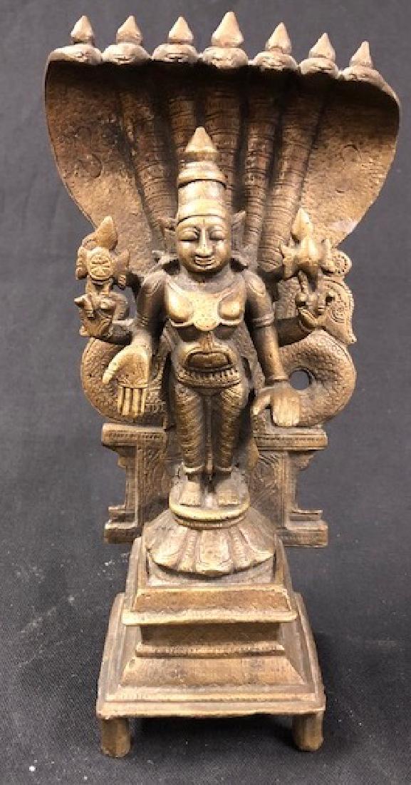 Vintage Bronze Lakshmi Statue: Description: Vintage bronze Hindu and Buddhist goddess Lakshmi statue. Heavy, solid piece depicts goddess on pedestal; back is protected by carved screen with snakes on side. Lakshmi is known to be th