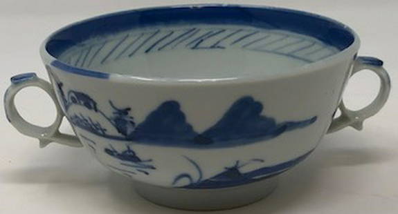 Delicate Antique Asian Porcelain Teacup w/ Handles: Description: Delicate, antique teacup with handles, decorated in traditional blue and white on exterior and interior. Beautiful, high glaze; Small, footed base. Material: porcelain. Measurement: