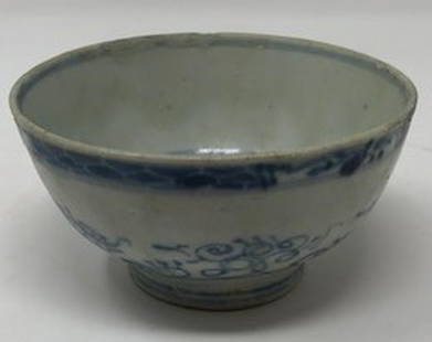 Antique Asian Porcelain Teacup: Description: Delicate, antique teacup, decorated in traditional blue and white scrolling on exterior and interior. Small, footed base. Material: porcelain. Measurement: approximate 4.5"w x 2.75"h