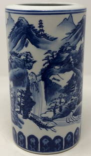 Splendid Porcelain Asian Vase: Description: Splendid porcelain Asian vase with high gloss finish. Smaller proportions allow for display in any setting. Cylinder shaped; blue and white landscape design on body. Material: porcelain.