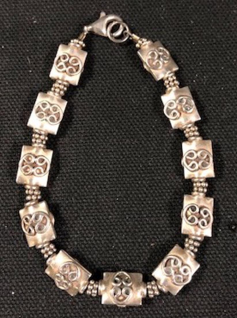 Petite Link Sterling Silver Bracelet: Description: Pretty, petite women's sterling silver link bracelet. Each link is square, with filigree center. Material: sterling silver. Measurement: approximate7"l (INCHES). Shipping cost: $10. Inter
