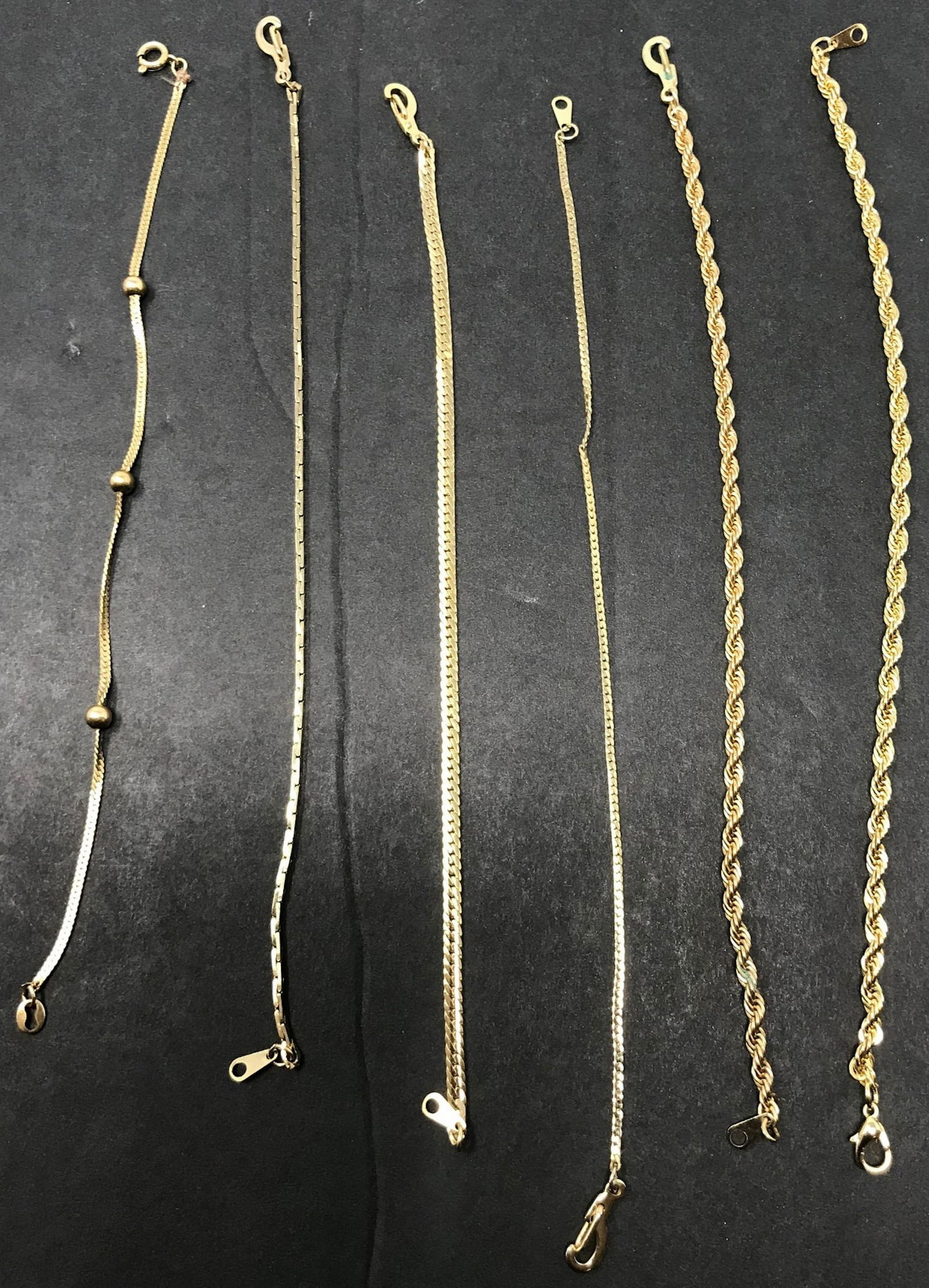 Set of 6 Gold Tone Bracelets: Description: Why wear only one when 6 look even better together! Fantastic set of 6 gold tone link bracelets, offering a nice variety of textures and links. Material: metal. Measurement: approximate 8