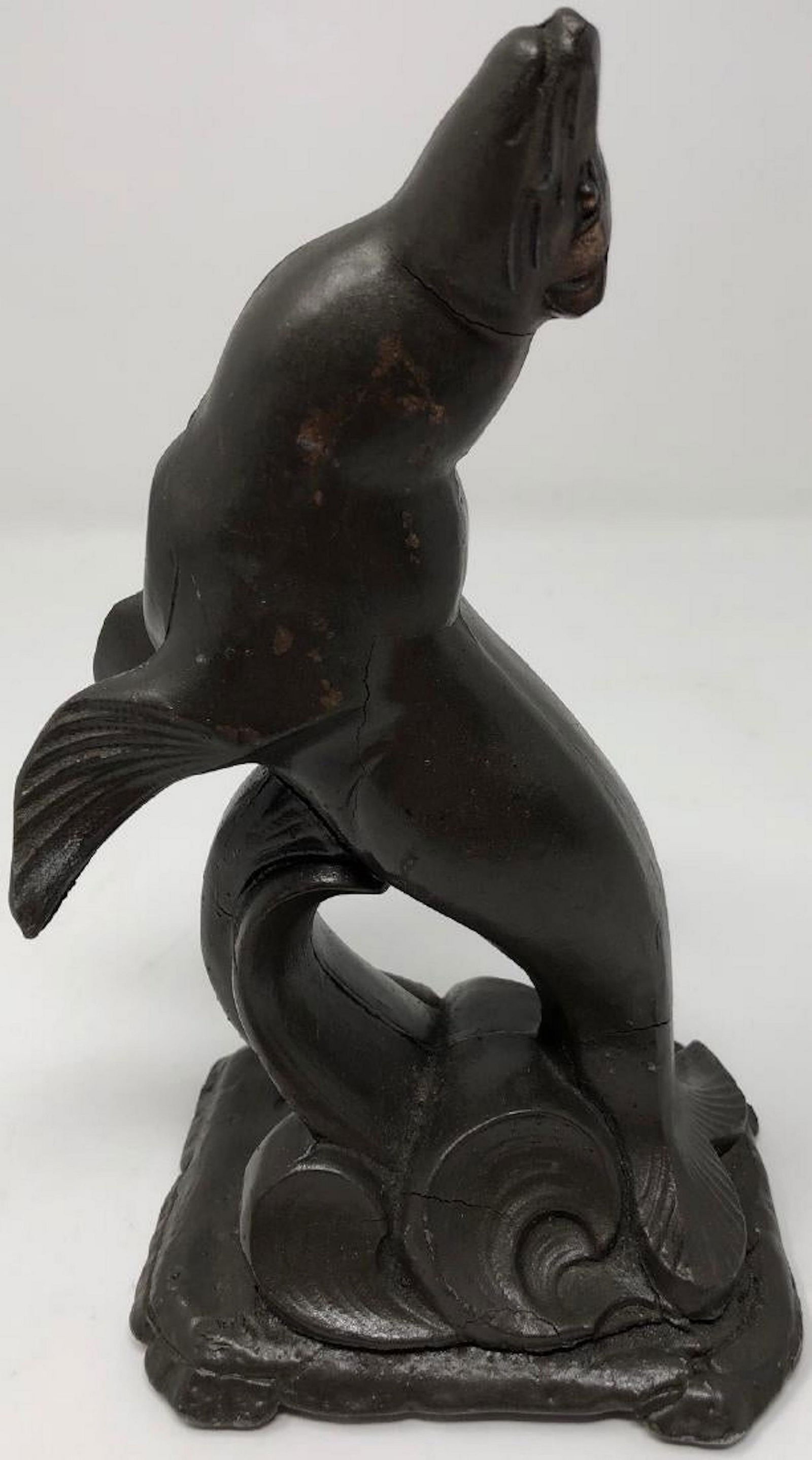 Le Verrier-Style Art Deco Seal: Description: Art deco Max Le Verrier-style joyful heavy metal/spelter cast sculpture of a seal breaking the water. Slight crack at tail. Measurement: approximate 9"h x 4"w (INCHES). Shipping cost: $17