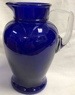 Elegant Cobalt Blue Glass Water Pitcher: Description: Elegant cobalt blue glass water pitcher with clear glass handle. Lovely art deco presentation. Material: glass. Measurement: approximate 8.50" (INCHES). Shipping: $50; different rate to