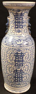 Glorious 24" Asain Porcelain Vase w/Handles: Description: Glorious tall Asian porcelain vase with porcelain handles; decorated in light blue florals with a overlay of Chinese characters. Lipped top; slight chip and small crack, repaired in
