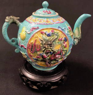 Qing Dynasty Magnificent Porcelain Teapot: Description: Qing Dynasty perfectly petite Asian porcelain teapot in dazzling blue green with relief pattern. Maker's mark inscribed on underside. Material: porcelain. Measurement: approximate 6"