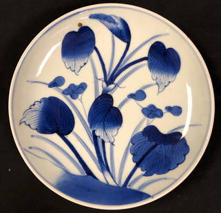 Qing Dynasty Chinese Plate: Description: Qing Dynasty Chinese porcelain plate; artfully decorated with graceful leaves in blue over bisque. One mark in glaze, reflective of age. Material: porcelain. Measurement: approximate